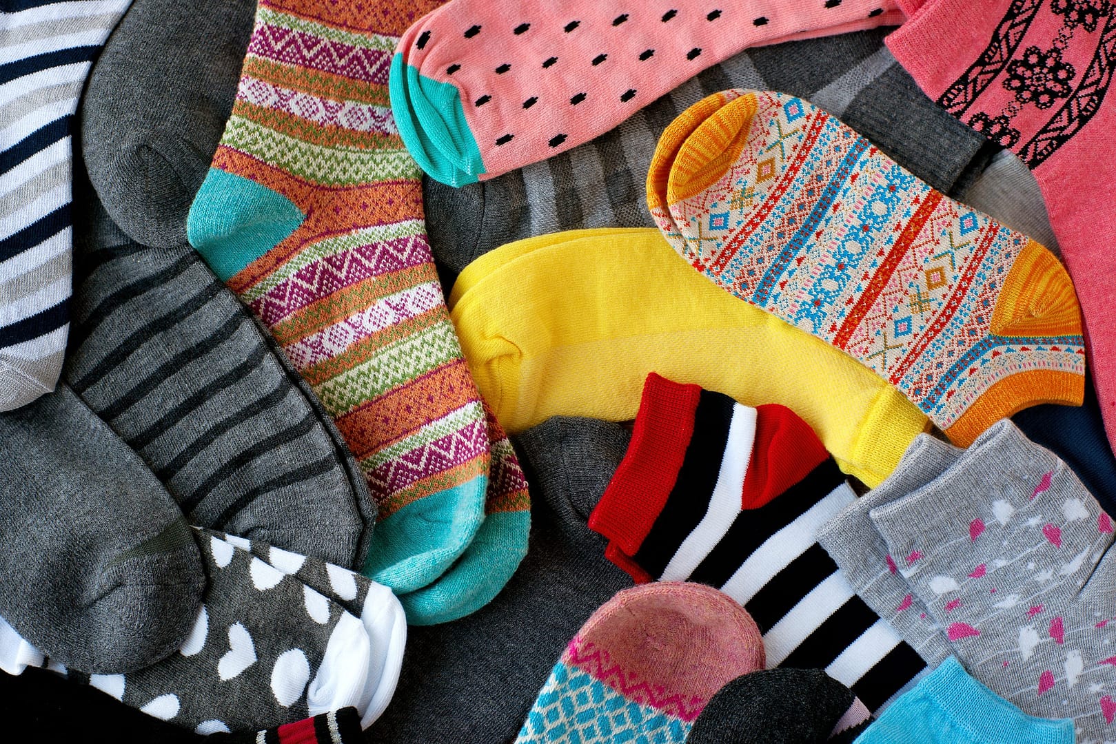 A pile of multi-colored socks. View from above. Many colorful so