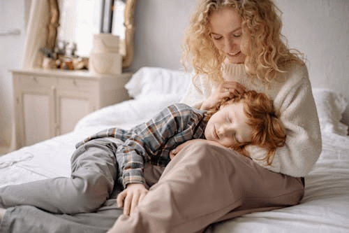 Kid laying on mom's lap